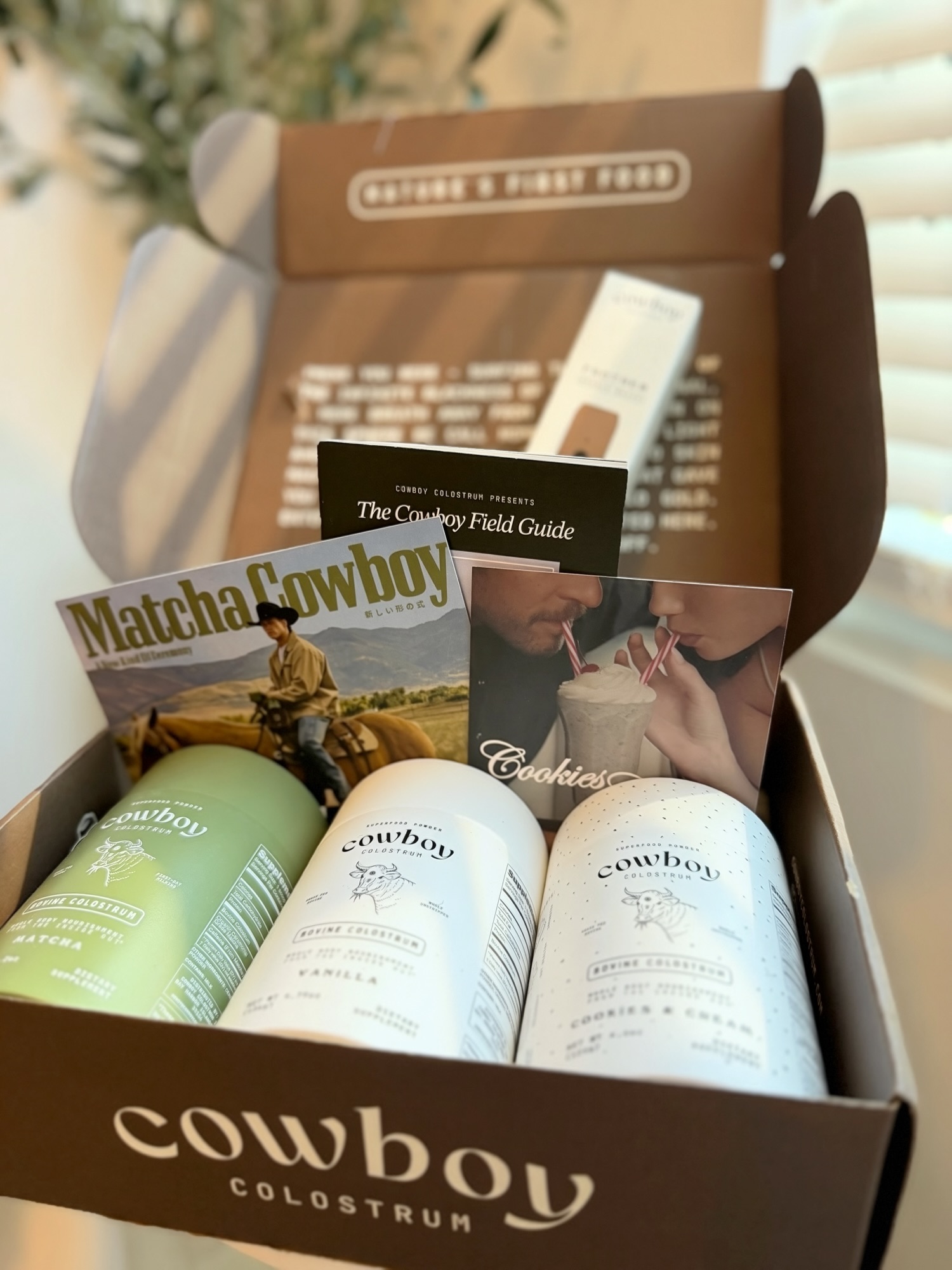 Cowboy Colostrum jars and packaging during an at-home unboxing