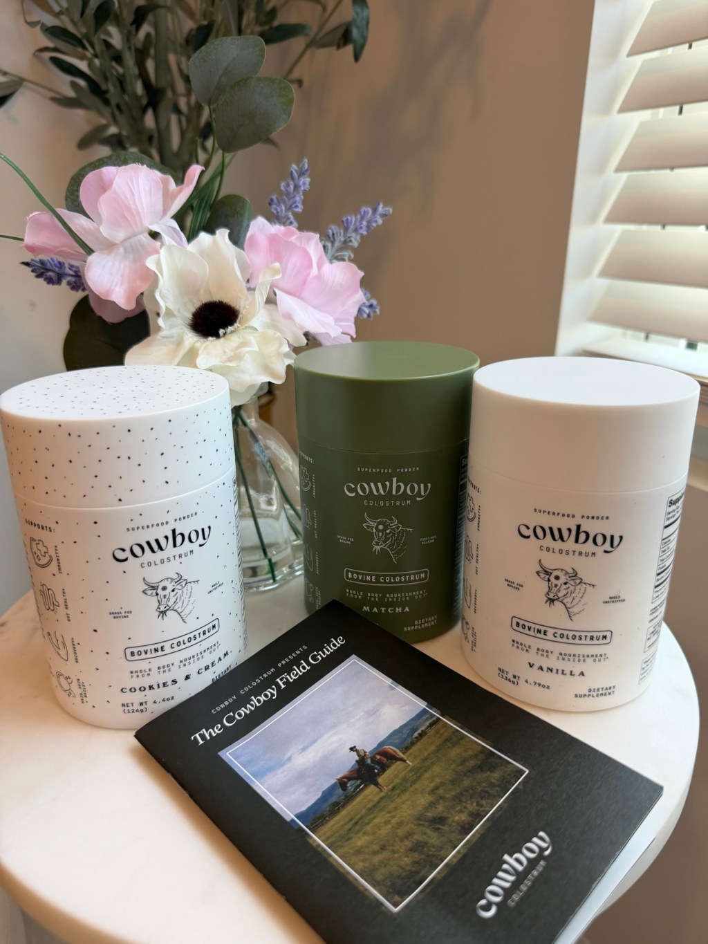 Cowboy Colostrum order with three flavors and printed Field Guide photographed after delivery